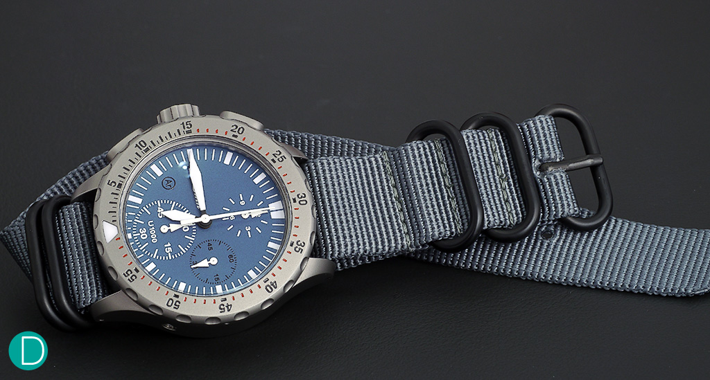 The Sinn U1000 (EXM6), tegimented submarine steel case with a beautiful matt blue electroplated dial. Watch is delivered with a matt blue silicone strap and this beautiful grey NATO strap.