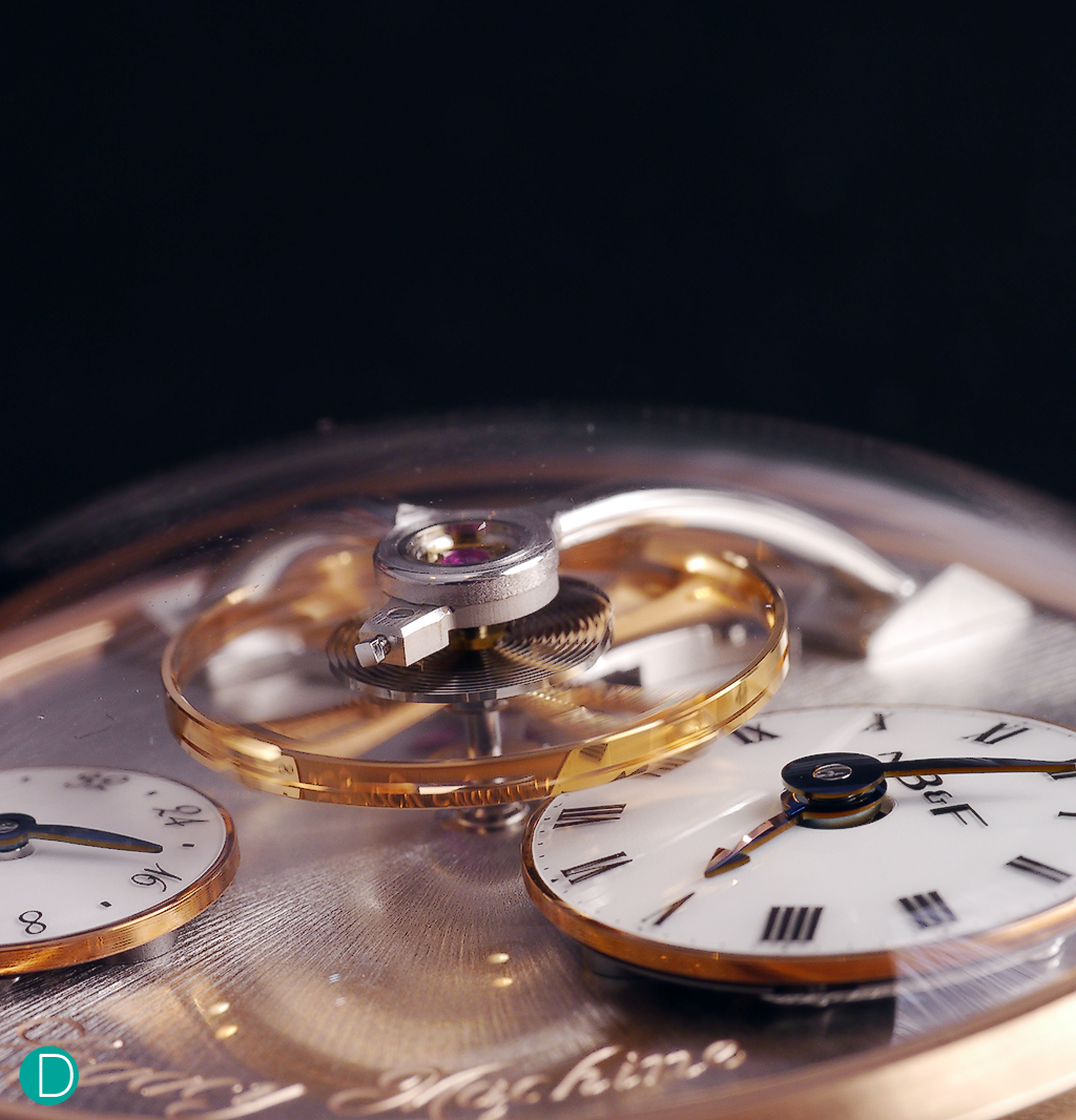 The large balance wheel, measuring 14mm in diameter, is suspended over the dial. 