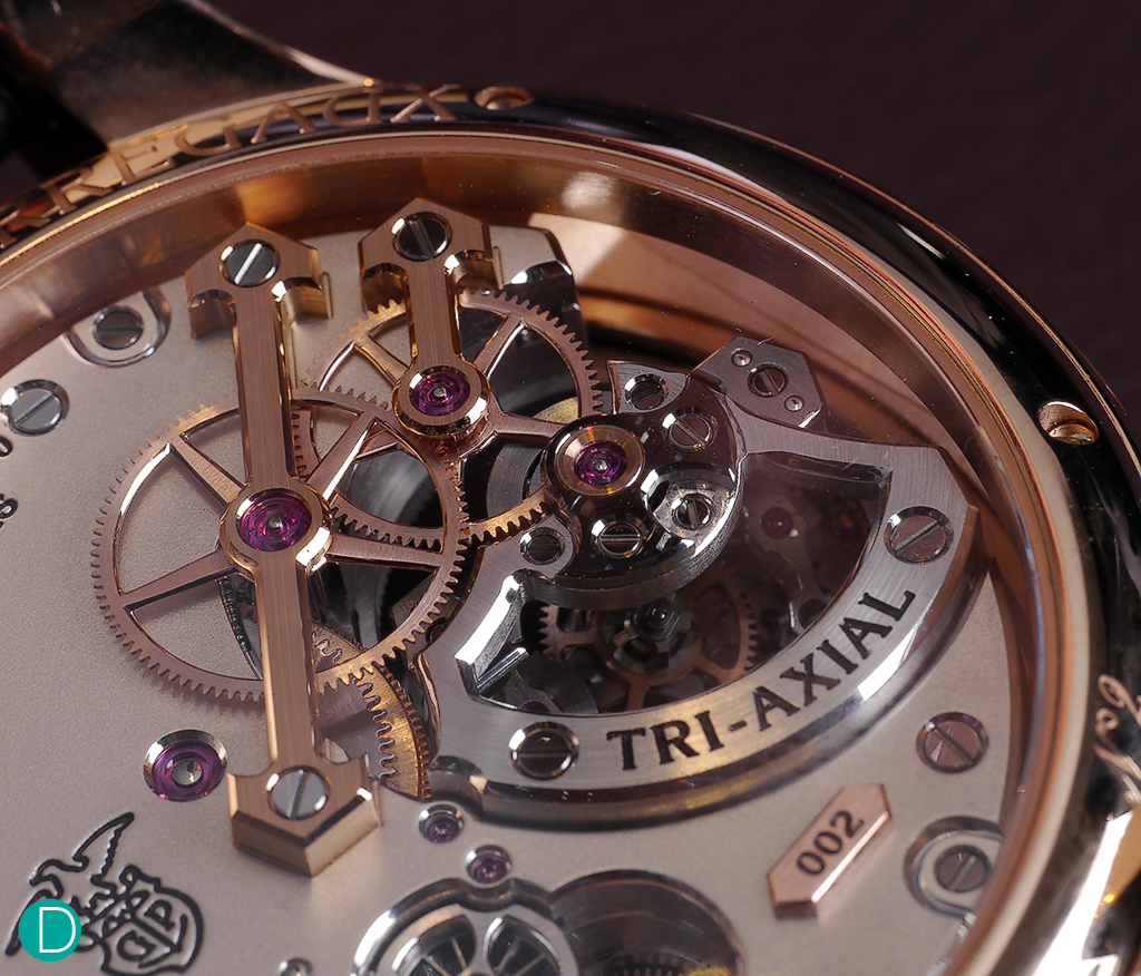 The rear of the Tri-Axial tourbillon, showing the bridges, which takes design cues from the traditional and iconic GP Tourbillon in 3 Golden Bridges. The double headed arrow bridge, crafted in rose gold and a bridge with stylistic reference to the same holds the drive system to the tourbillon.