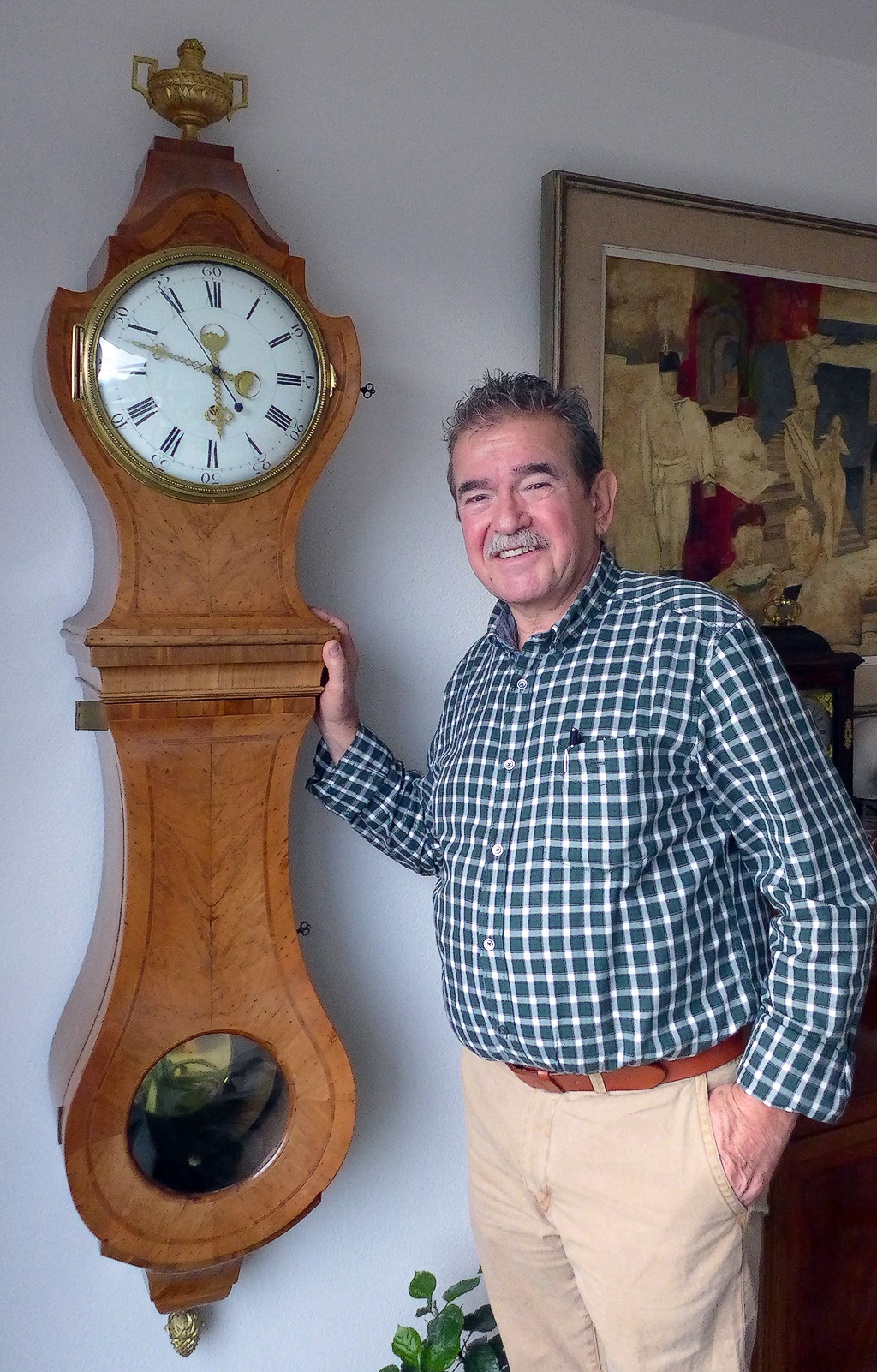 Mr Baumgartner Senior, with one of his vintage clocks on display at his home.