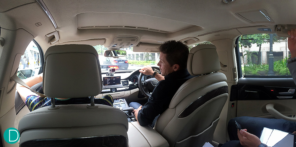 Driving the Audi A8 around the streets of Singapore, while answering questions.