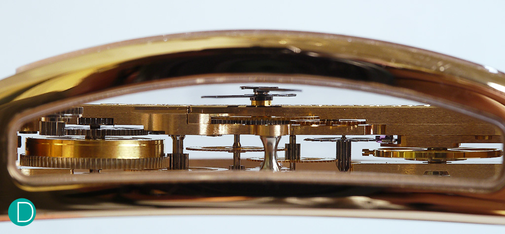 The movement of the iconic Corum Golden Bridge, visible from the side window, seemingly suspended.