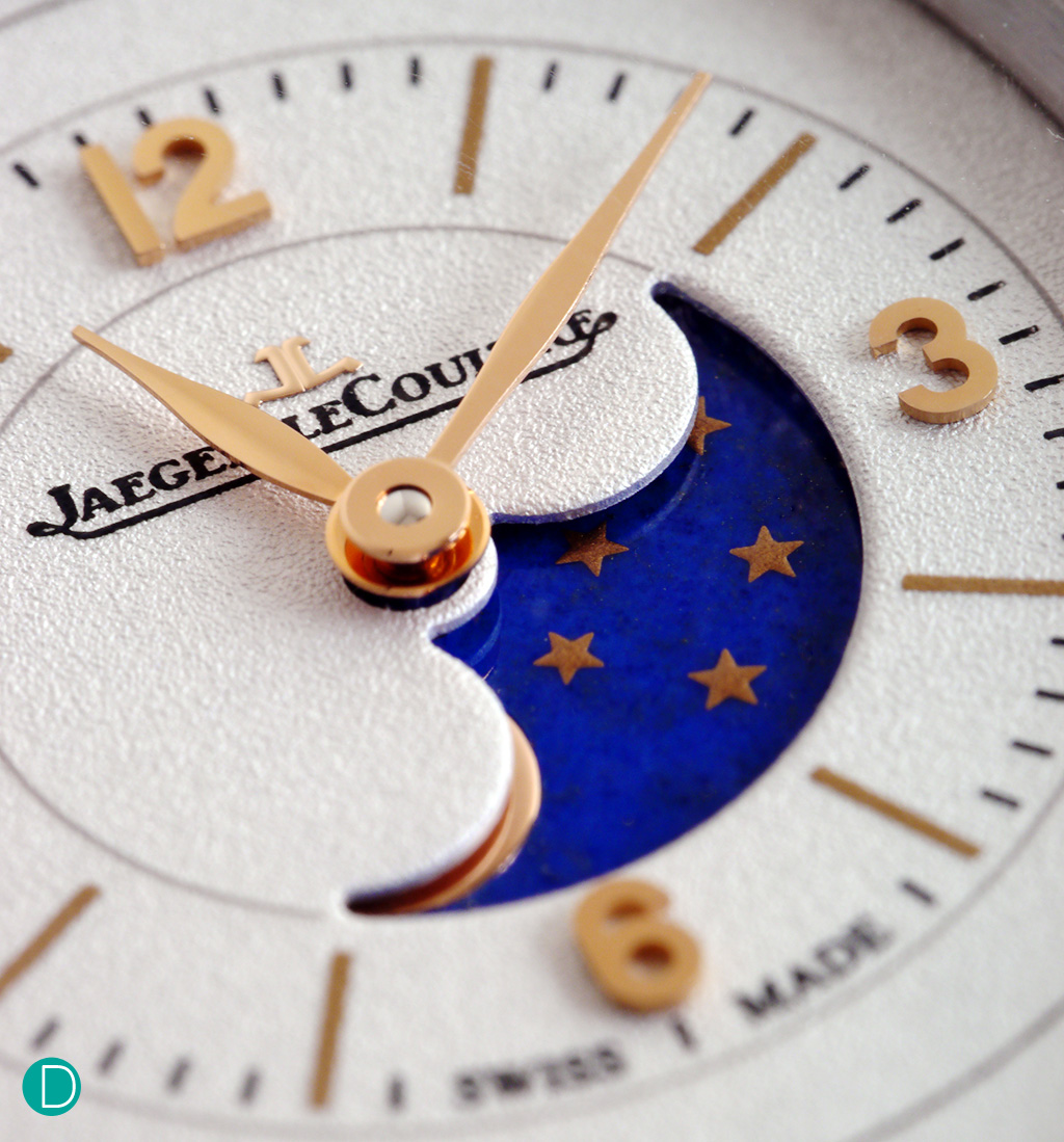 The moonphase, displayed as a cut out on the hour-minute subdial. The gold moon and stars accent the magnificent blue of the disk.