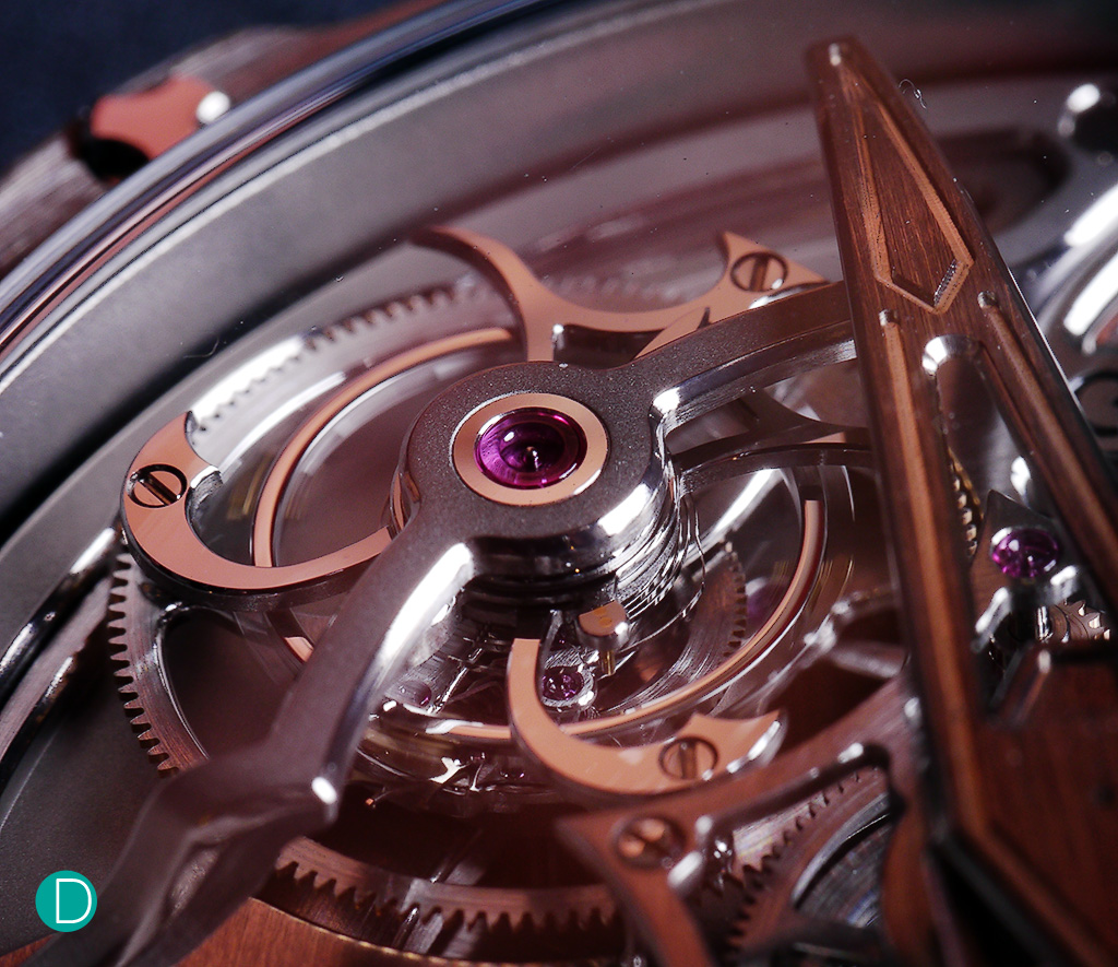 Detail of one of the tourbillons. The gold hue is due to reflection from the environment. The tourbillon is hand finished, each of the beautiful stylized arm is well polished to a high degree. The design of the rather minimalist cage has elements of traditional watchmaking like the sharp horns, both inward and outward angles which are used to demonstrate craft.