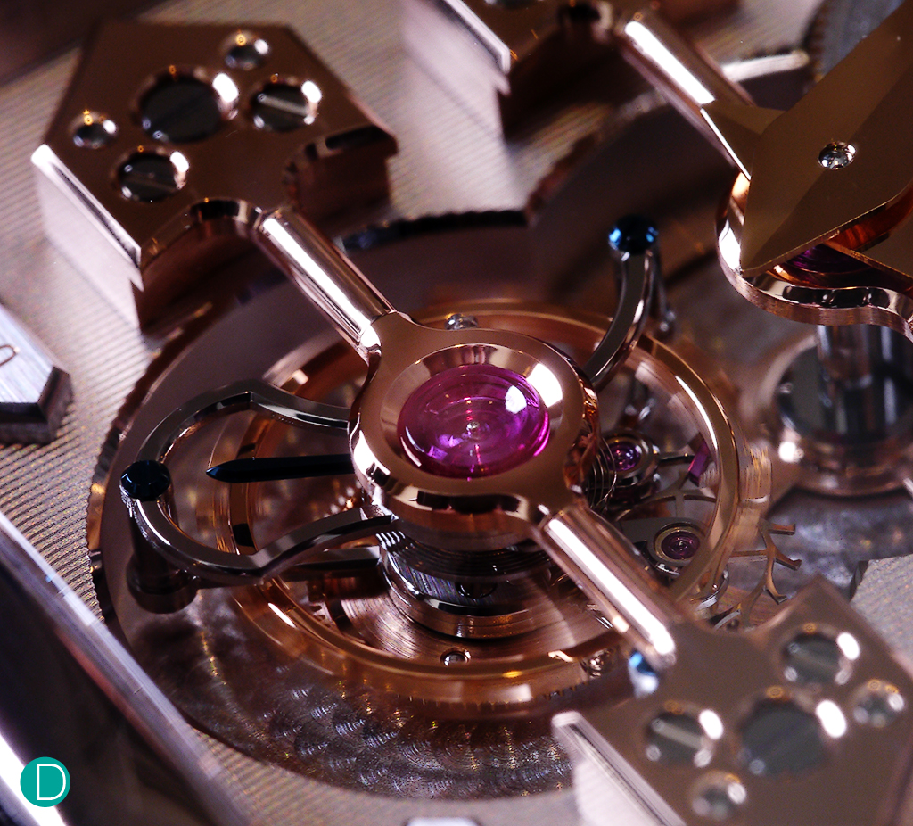 The tourbillon. The huge ruby endstone is exceptionally large and beautiful. Note the finishing on the arrow heads, which are anglaged, and polished. Also the tourbillon bridges get a similar finish. 