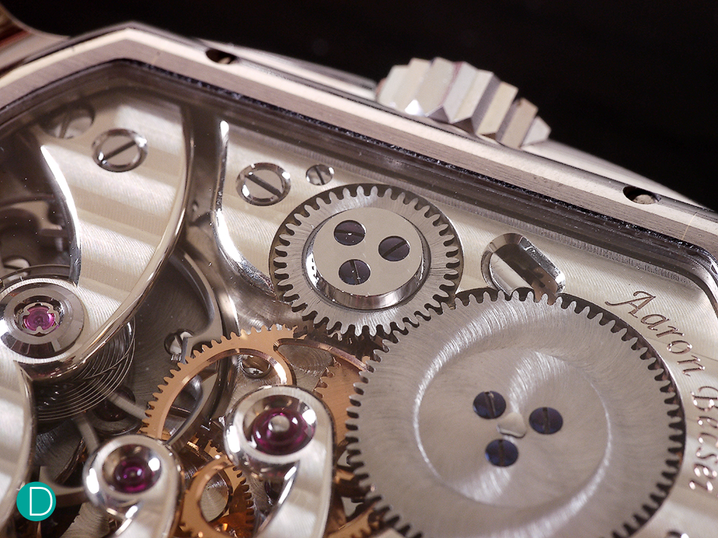 Another close detail photograph of the movement, showing the magnificently machined click and transmission wheel. The canon wheel is also visible here, held in place by the large, brilliant jewel with its beautifully executed inward curve on the cock.