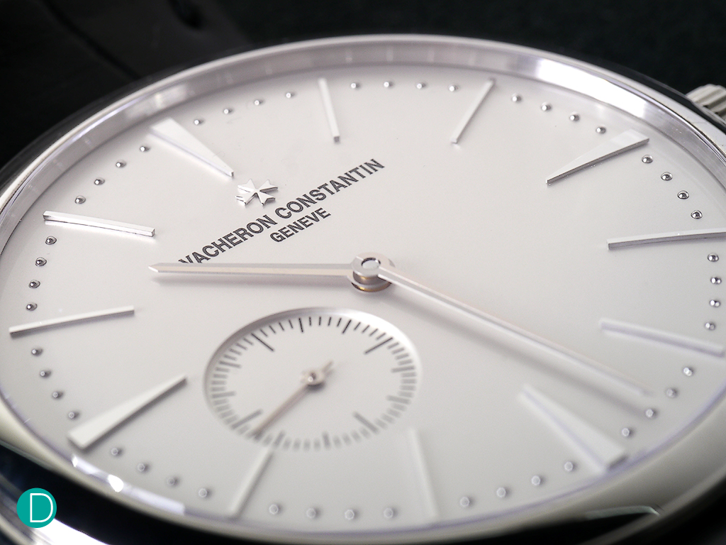 The dial design is genius. Simple. Elegant. Yet the proportions are perfect. The long hour markers exude an aristocratic elegance. The hands are slim, and refined. The Maltese Cross, the VC logo, is an applique, and hovers a print of the maker's name. 