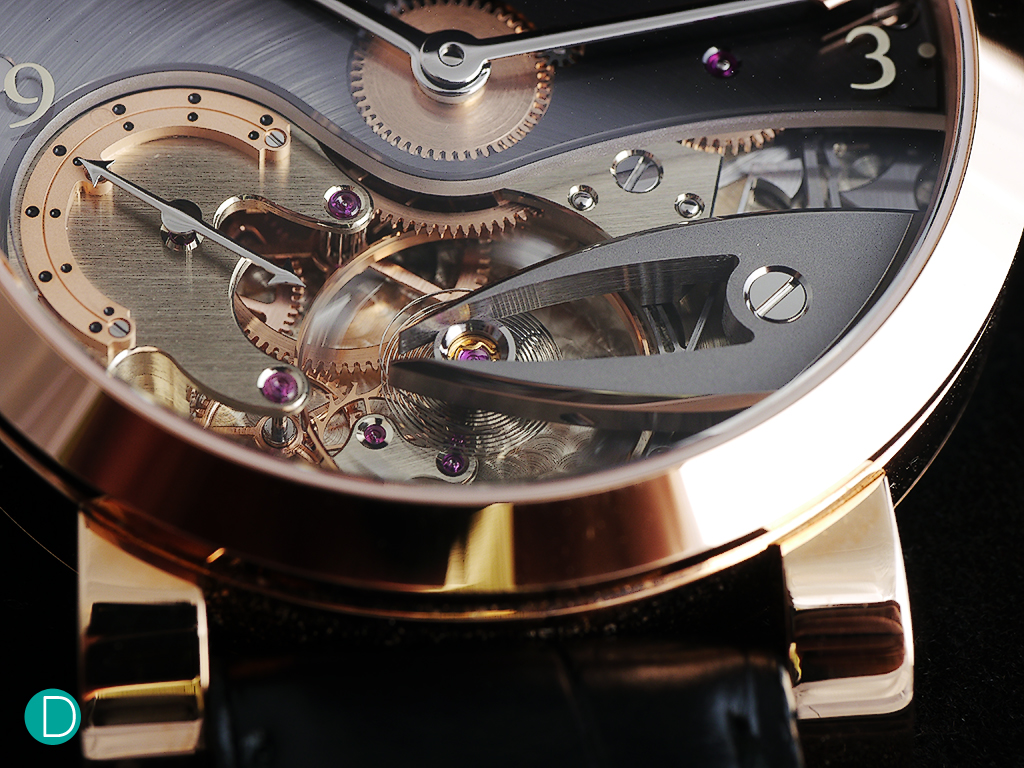 The escapement. The escape wheel's cock is in a stylized form, looking like pincers, give the watch its characteristic look. At Charles' request, it is finished with a frosted texture to contrast top the brilliantly polished anglage. 