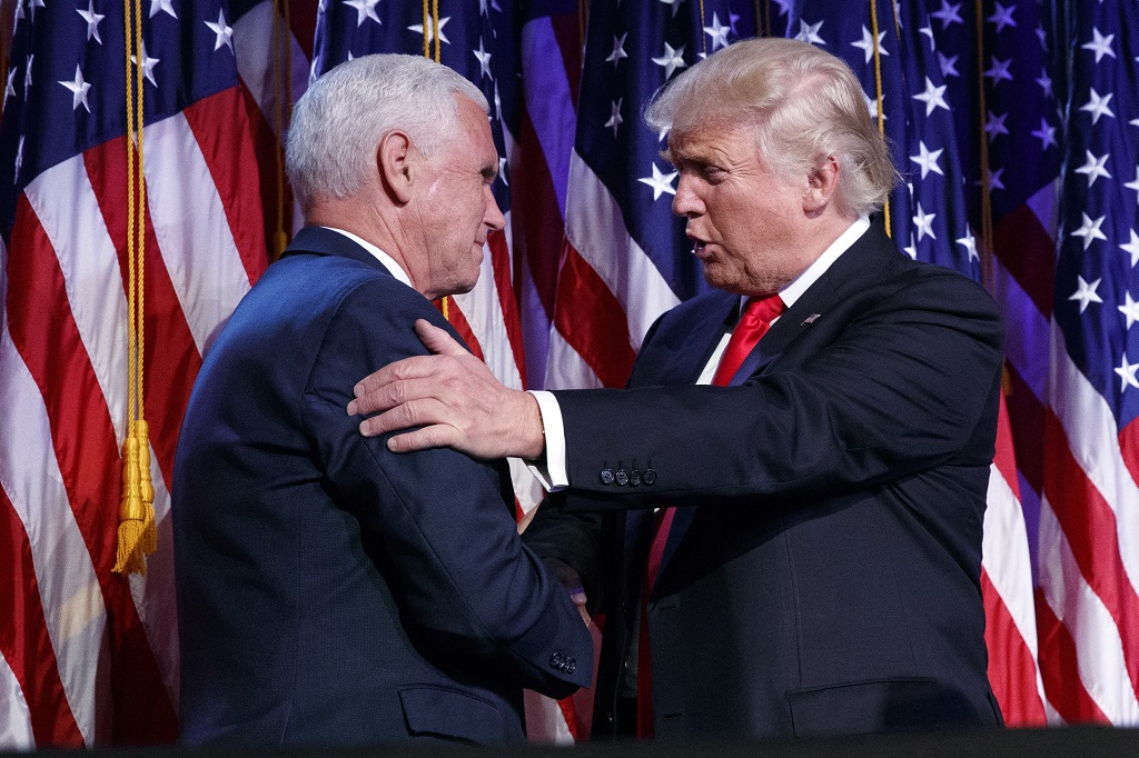 President-elect Donald Trump, right, shakes hands with vice president-elect Mike Pence during an election night rally, Wednesday, Nov. 9, 2016, in New York. (AP Photo/ Evan Vucci)