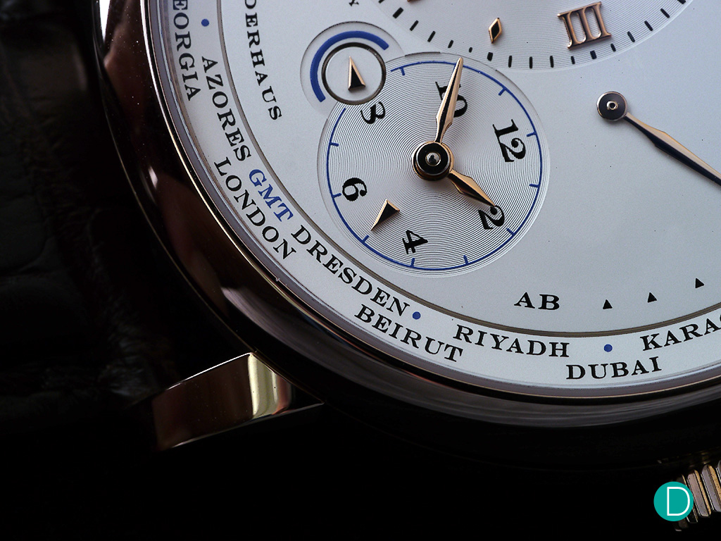 Dresden on the cities dial in place of Berlin in the regular edition is one of the distinguishing features of the Lange 1 Timezone Honey Gold.