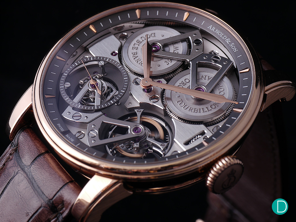 Arnold & Son Constant Force Tourbillon. The tourbillon on thelower right of the cage moves in step with the constant force mechanism on the lower left. And creates a beautiful animated spectacle.