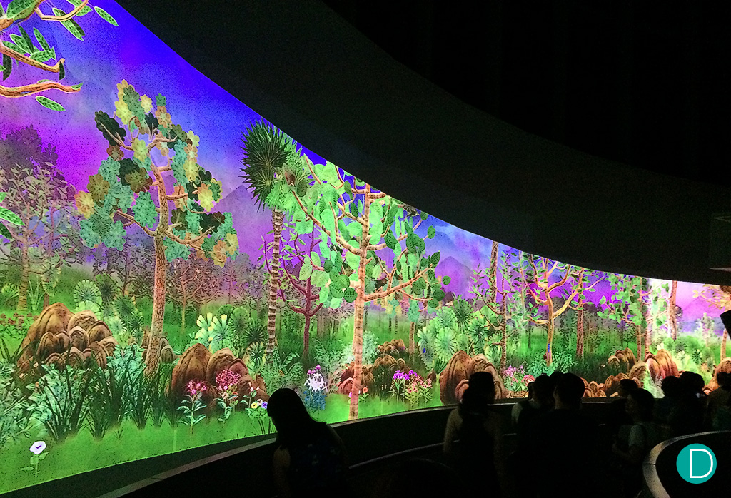 The interactive digital wall. The images are based on Faquhar's drawings, and as a result look like they moving on a giant cartoon landscape.