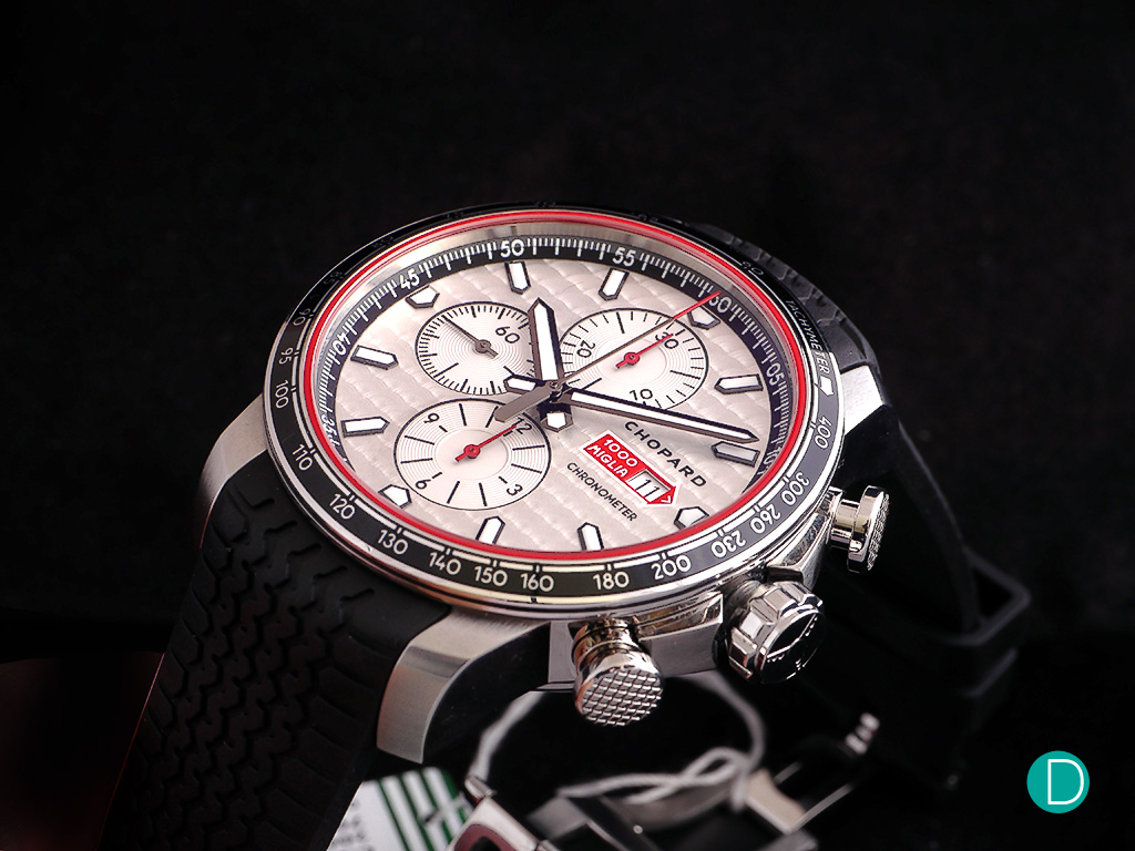 The silver dial provides an excellent contrast with the tachymeter bezel and bright red accents of the timepiece.